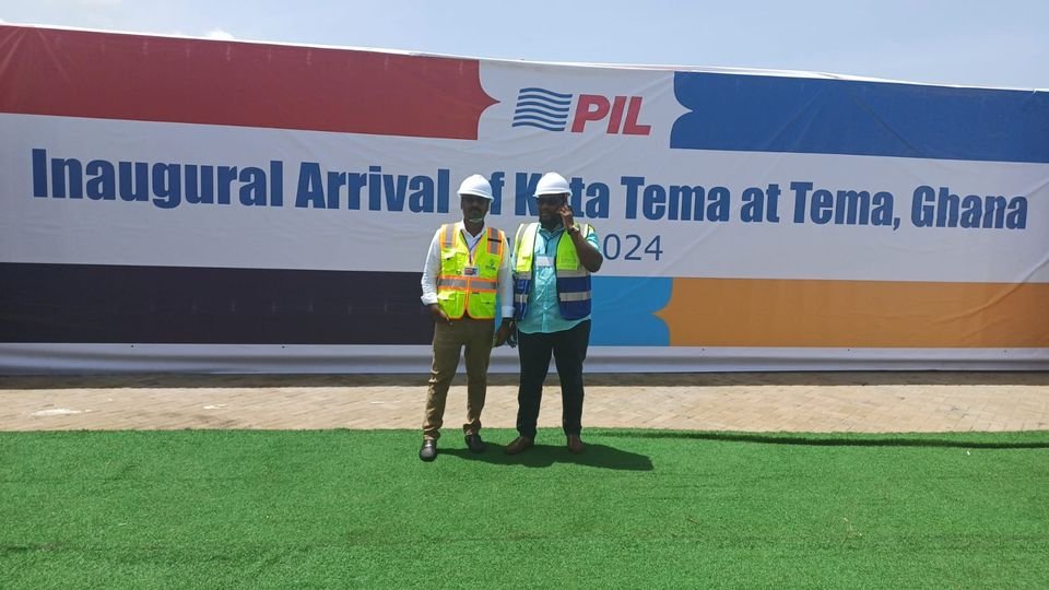Two Transit Cargo Limited staff in front of the PIL banner for the inaugural arrival of the Kota Tema at Tema, 2024