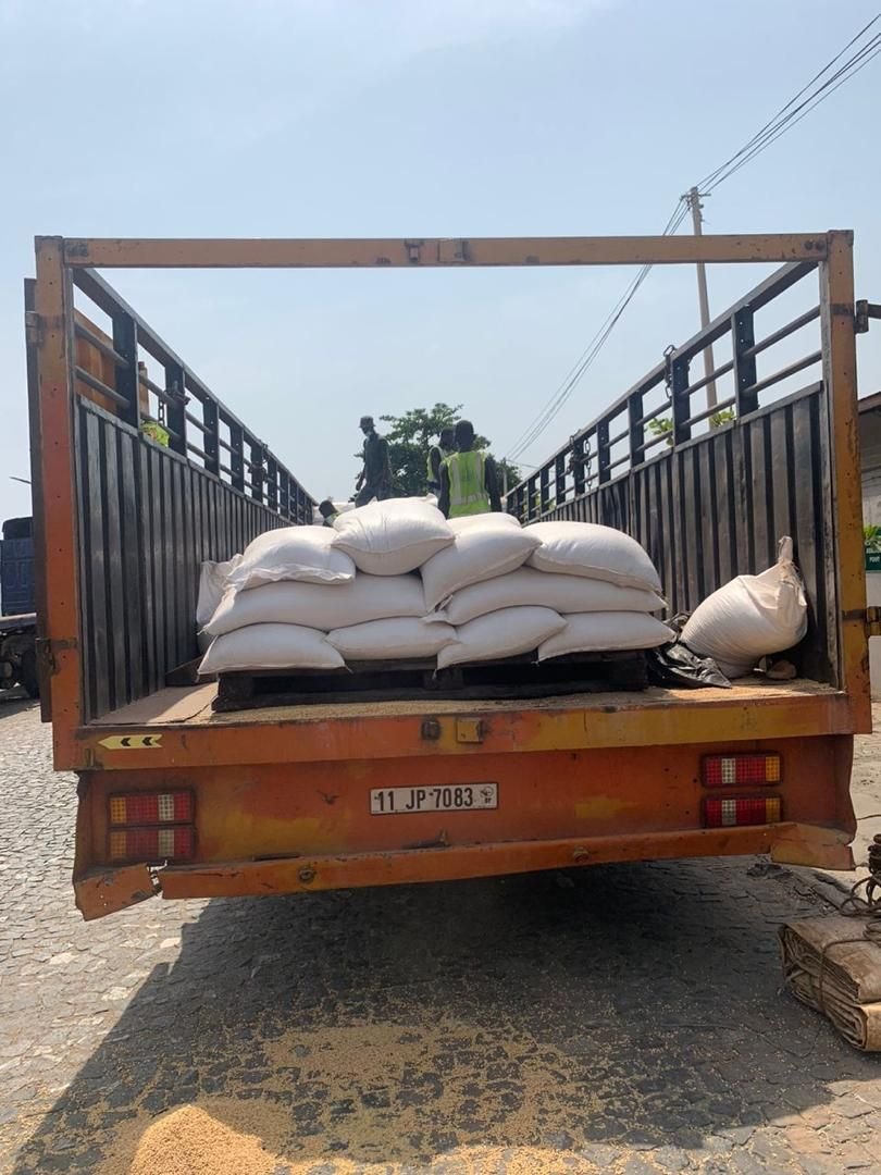 Flatbed truck loaded with white sacks of bagged produce
